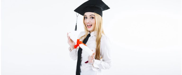 Smiling graduate in cap holding diploma, symbolizing academic achievement. Focus on How HNDs Are Assessed.