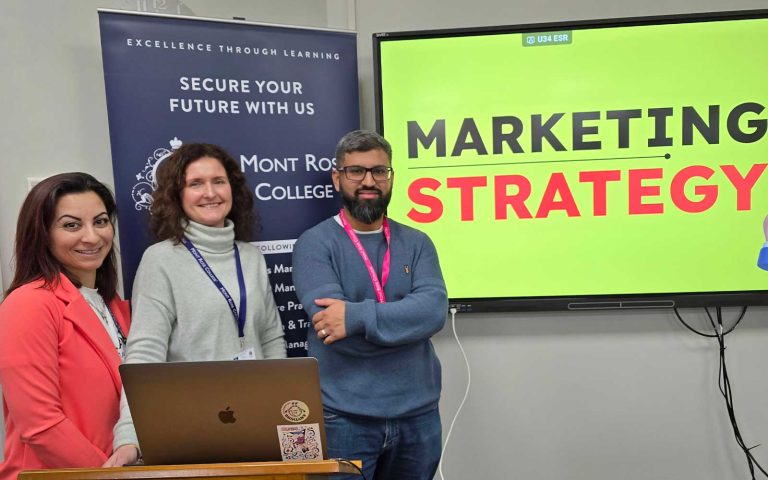Three presenters standing by a screen displaying “Marketing Strategy” during the Empowering Students with Marketing Strategy – Zamil Zareen Session.