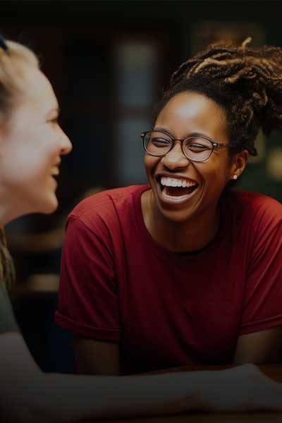 volunteering students sharing a joyful conversation, reflecting teamwork, community engagement, and positive social impact through meaningful activities