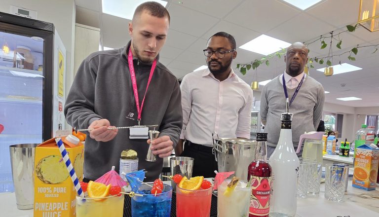 Students preparing colorful mocktails during a Hospitality Practical Workshop at Mont Rose College with instructor guidance.