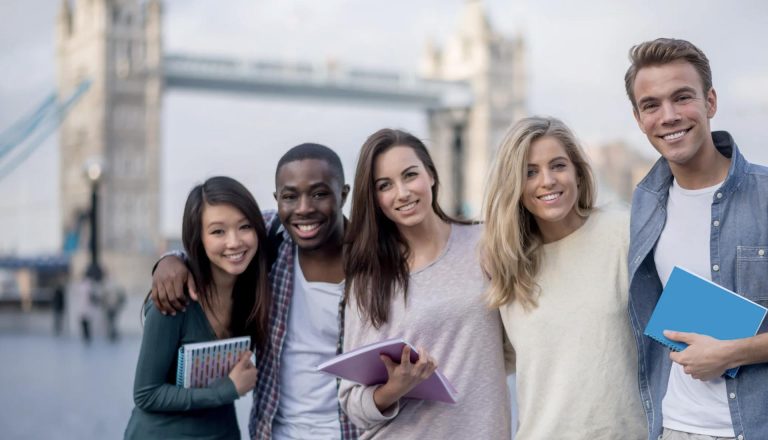 Group of HND students smiling near Tower Bridge, representing mastering work-life balance as an HND student.