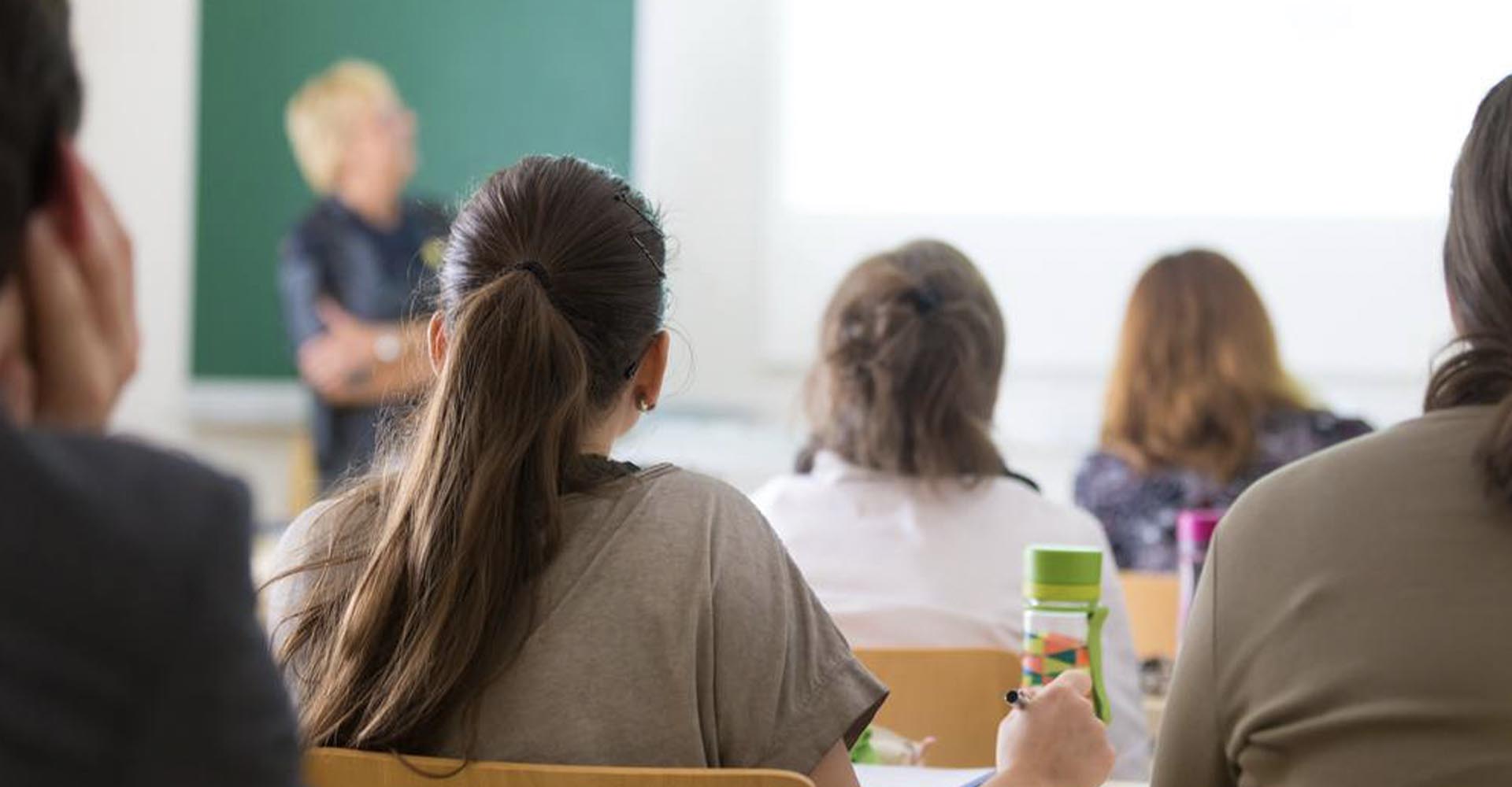 Students sitting in a classroom listening to a lecture, representing the concept of HND vs Higher Education Diplomas.
