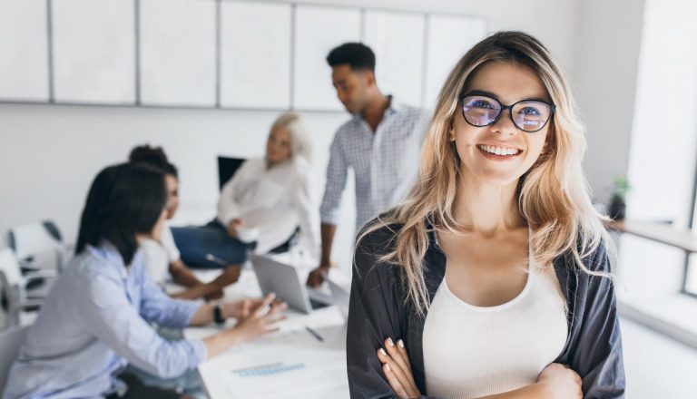 Confident young professional smiling in an office setting, symbolizing career success through HND and MBA qualifications.