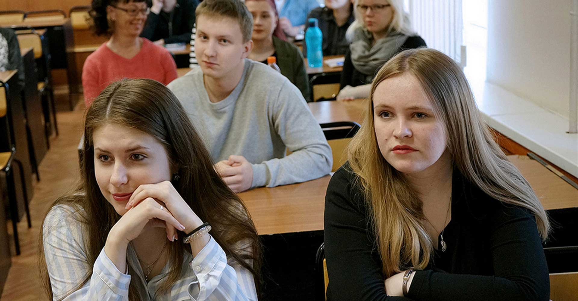 Students attentively listening in a classroom, reflecting focused learning in the context of HND vs. Technical Diplomas.