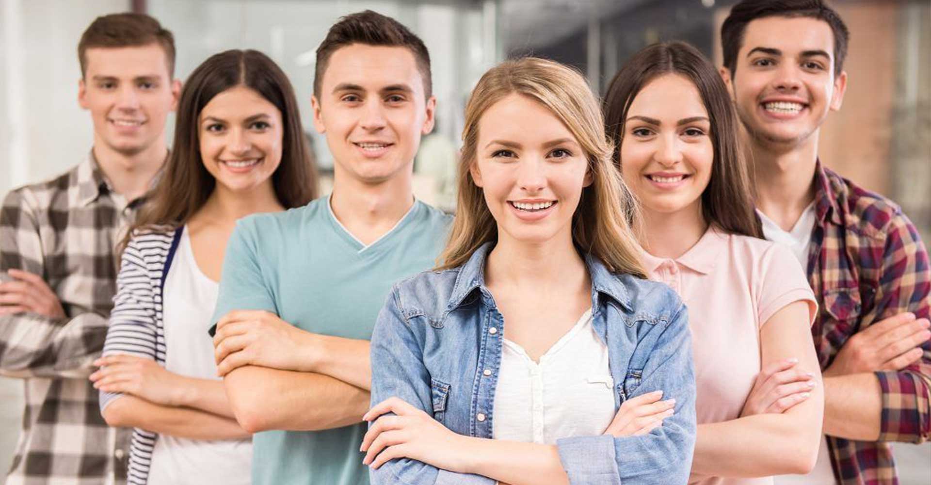 Confident students standing with arms crossed, representing entry requirements for HND in higher education settings.