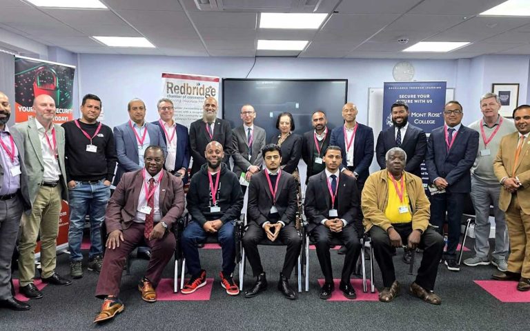 Group of professionals posing at Redbridge Chamber of Commerce meeting, highlighting networking and business collaboration.