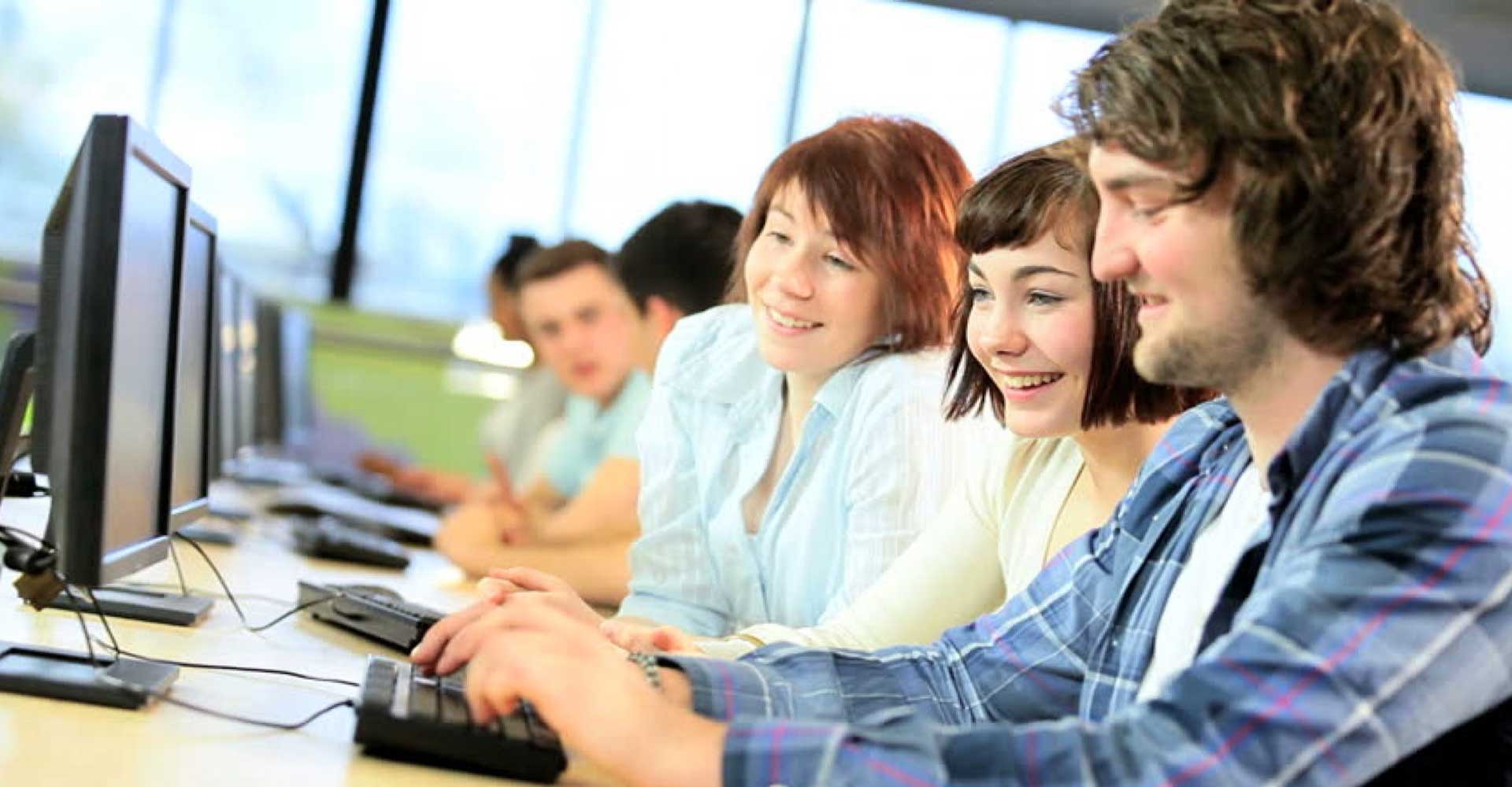 International students working on computers in a classroom, representing HND entry requirements for international students.