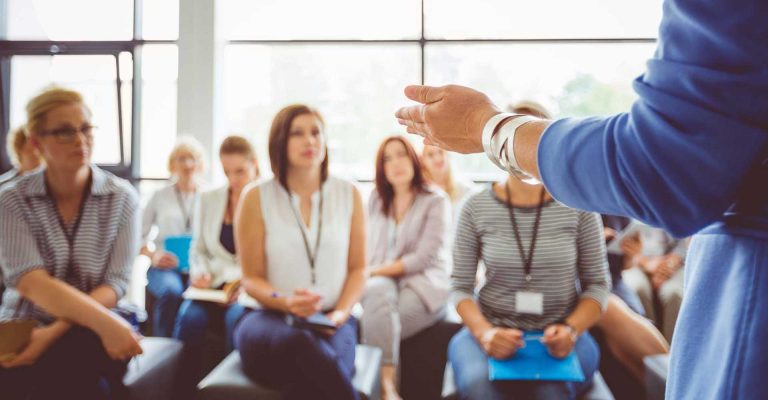 Instructor addressing attentive adult learners in a classroom setting highlighting HND academic prerequisites for course entry