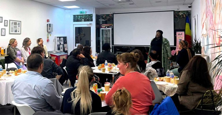 People attending a Mind Matters Mont Rose College event with a speaker presenting in front of a seated audience.
