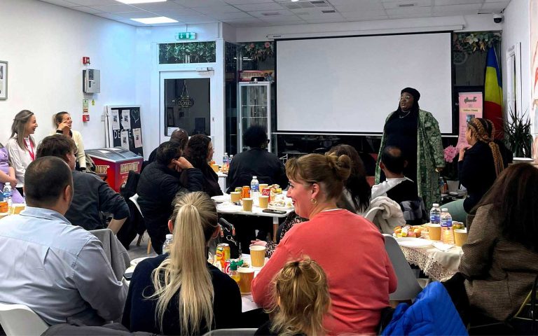 People attending a Mind Matters Mont Rose College event with a speaker presenting in front of a seated audience.