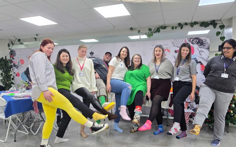 Staff and students showing off mismatched socks for Odd Socks Day at Mont Rose College, celebrating uniqueness and inclusion.