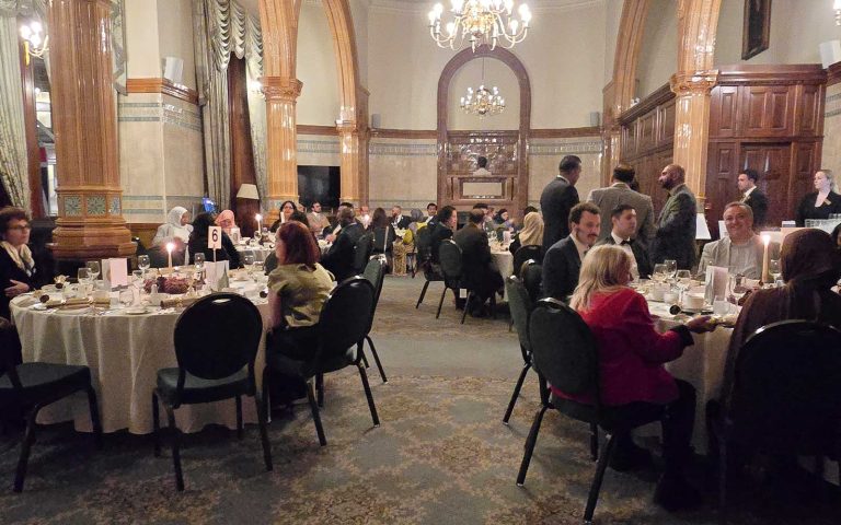 Guests dining in an elegant hall at the Mont Rose College Christmas Dinner 2025, with candlelit tables and festive atmosphere.