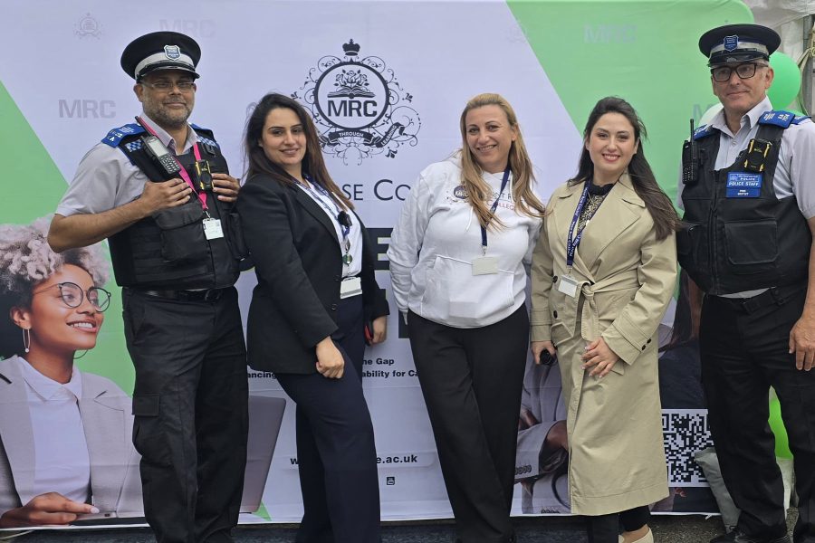 Group of staff and police officers posing at Mont Rose College backdrop, promoting collaboration and opportunities at Career Fair 2025