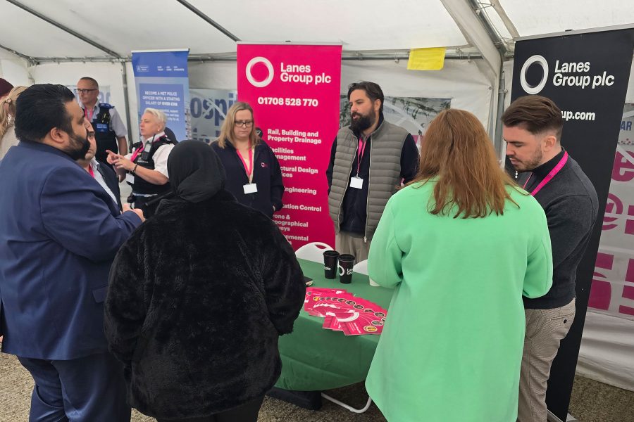 Visitors speaking with exhibitors at Lanes Group booth, networking and exploring opportunities during Career Fair 2025