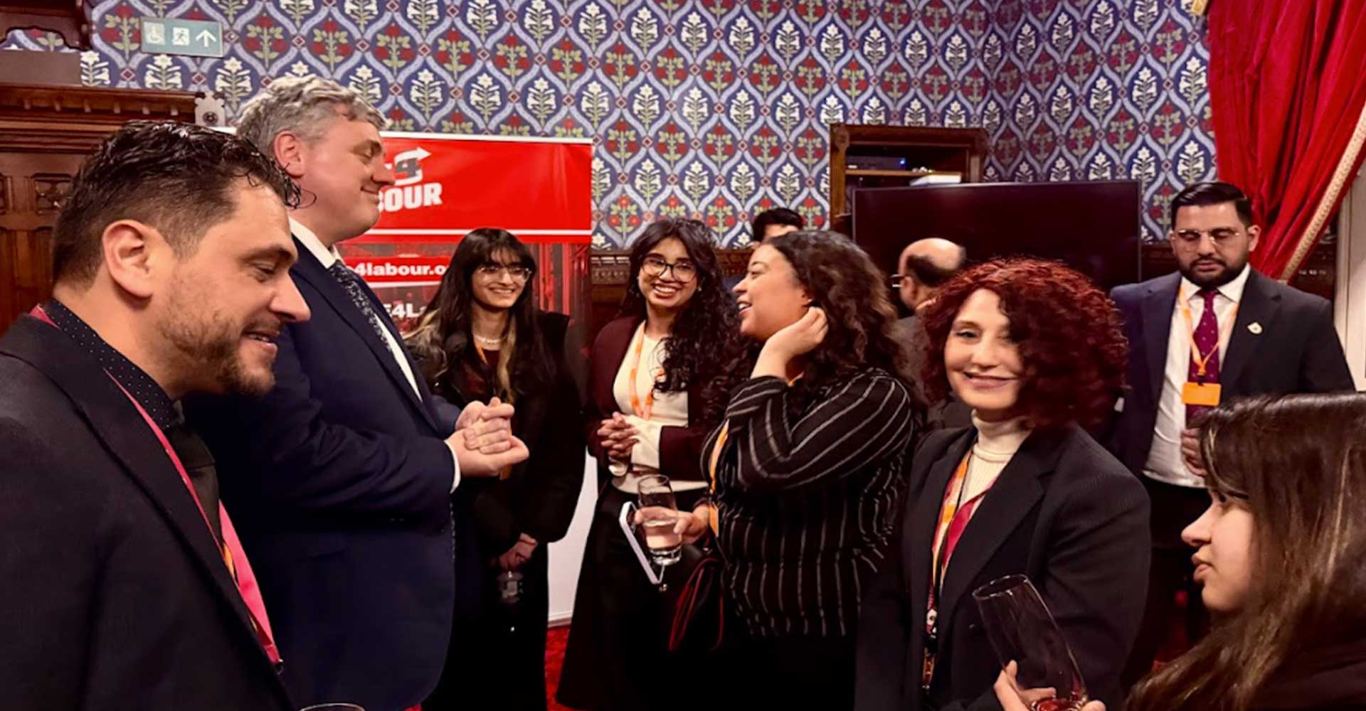 Students networking with professionals at UK Parliament event, highlighting UK Parliament networking event students engagement.