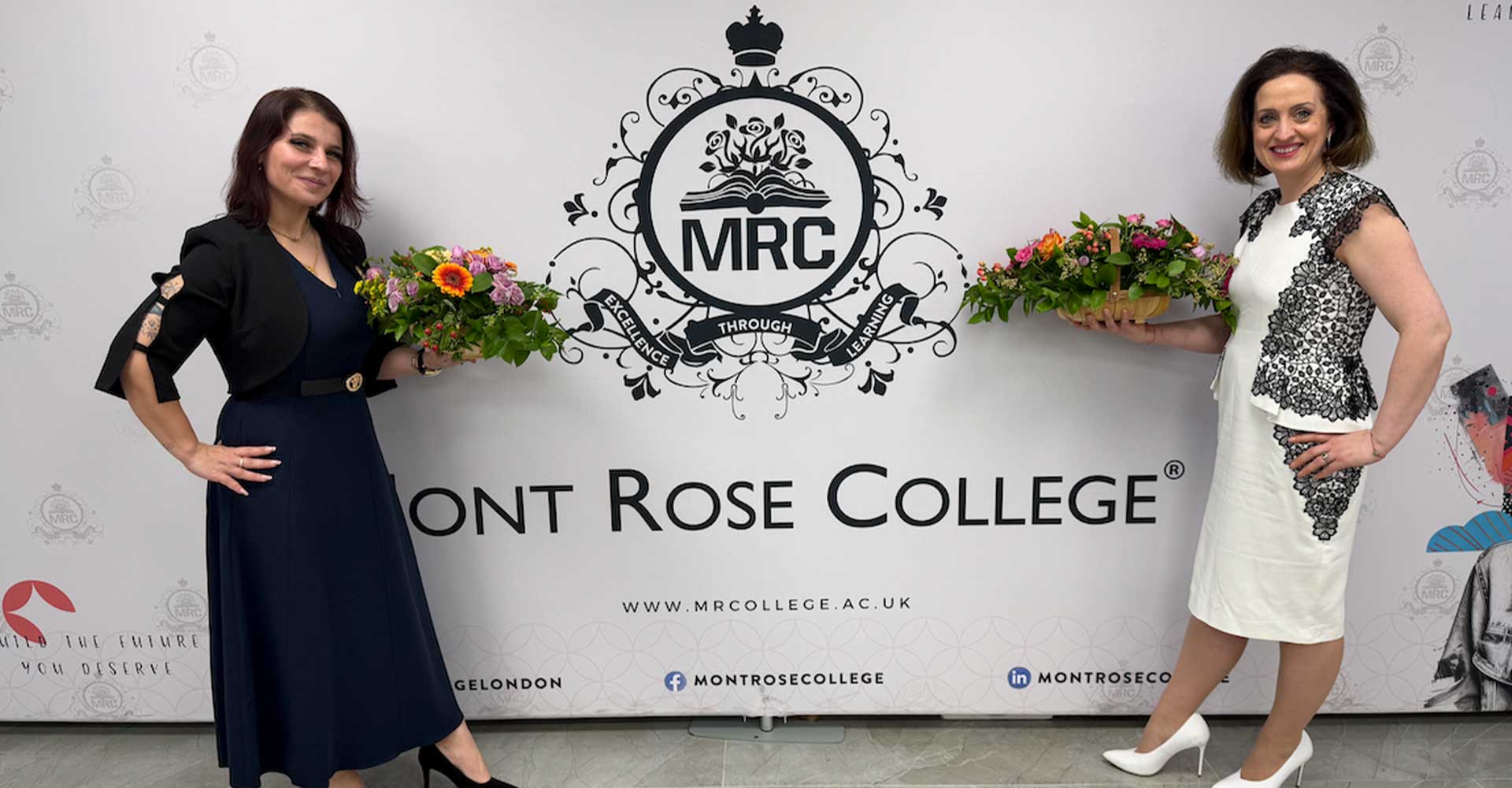 Two women holding flower arrangements and celebrating International Women’s Day 2026 in front of the Mont Rose College backdrop.