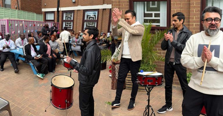 Participants playing drums and applauding during the Drum Circle Event at Mont Rose College, fostering community engagement and teamwork.